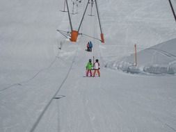 people on the ski lift on a sunny day