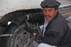soldier adjusting skid chain