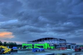 construction vehicles in the cloudy twilight