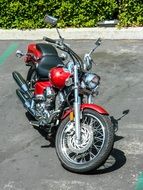 red motorcycle stands on the road
