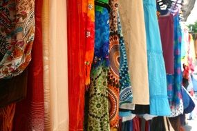 selling colorful clothes on the market in Spain