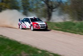 race car on the road with dust