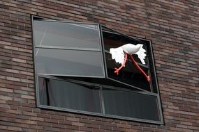 toy stork on the window in Amsterdam
