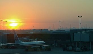 passenger plane at the airport on the background of the dawn