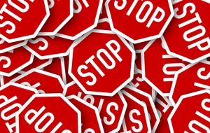 stop road signs are on top of each other