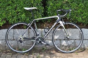 cannondale road bicycle parked at stone fence