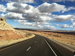 sky with white clouds over the highway