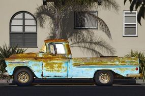 rusty truck near the building