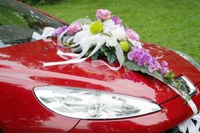 a bouquet of flowers on a wedding car