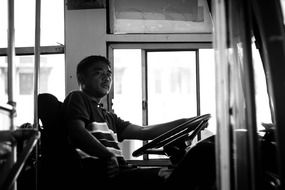 driver of a bus in black and white background