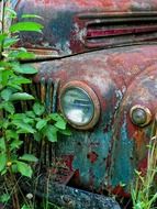 headlight on a rusty vintage car