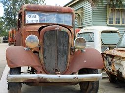 rusty retro car near the house
