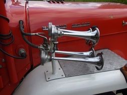 horns of a red classic car