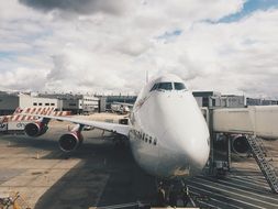 white clouds over airplane at the airport