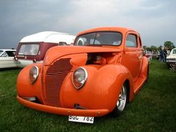 orange car on green grass