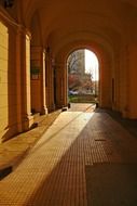 sun lighting through arched gateway