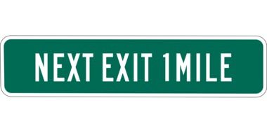 green road sign next exit 1 mile