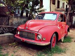 wrecked vintage car parked on a city street