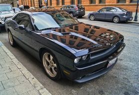 black high-speed car on a city street