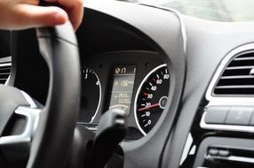 hand on steering wheel of modern car, driving