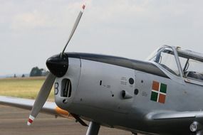 gray airplane with propeller