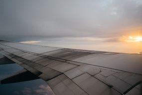 wing of the plane against the bright sun