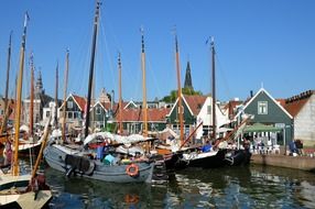 fishing boats on the water near the houses