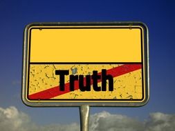 no truth yellow street sign