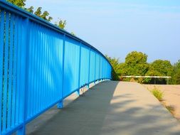 blue fence along the road