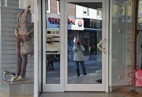 facade with a mirror reflection near the road