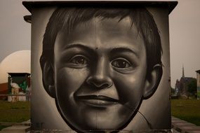 child's portrait painted on a gray wall