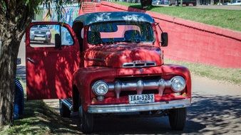 vintage red ford car with open door