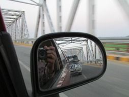 reflection in the side mirror of the car