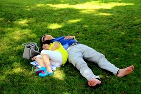 tourists rest on the green grass