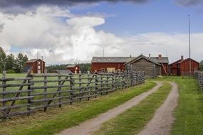 countryside road along a wooden fence