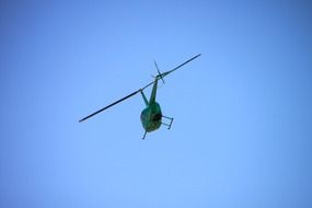 helicopter in flight in the blue sky