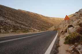 warning signs on a mountain road