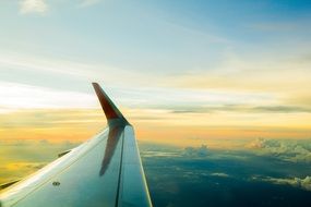 the wing of the plane in the clouds