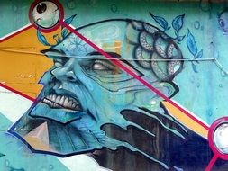 graffiti in the form of a man's head on the wall