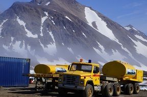 tankers at the foot of the mountains in greenland