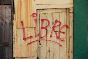 red inscription on a wooden door