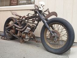 rusty motorcycle near the wall