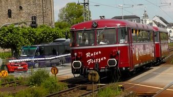 Beautiful and colorful railbus among the plants on the street