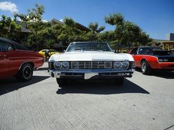 white vintage chevrolet car in parking