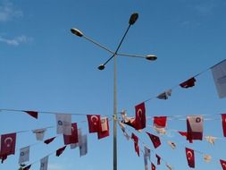 flags and pennants on lines around street lantern at sky, turkey