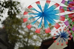 colorful windmills at grey sky