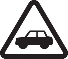 triangular sign with the image of a car