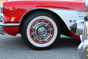 side of vintage car with red and white tire