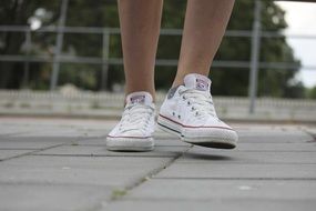 Beautiful white sneakers on the feet