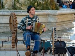 Street musician with different old instruments